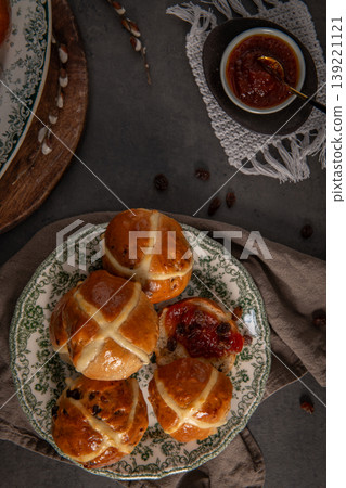 Freshly Baked Hot Cross Buns Served with Fruit Jam on a Vintage Plate 139221121