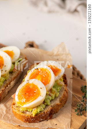 Close Up of Avocado Toast with Jammy Soft Boiled Eggs Close Up of Avocado Toast with Jammy Soft Boiled Eggs 139221160