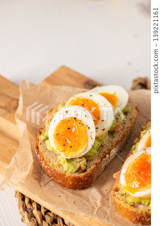 Sourdough Toast with Smashed Avocado and Soft Boiled Egg Slices Sourdough Toast with Smashed Avocado and Soft Boiled Egg Slices 139221161
