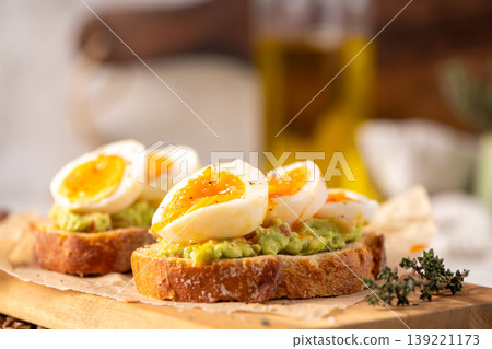 Soft Boiled Egg and Smashed Avocado Toast on Artisanal Sourdough Soft Boiled Egg and Smashed Avocado Toast on Artisanal Sourdough 139221173