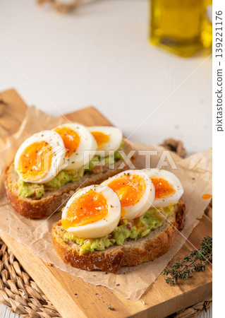 Sourdough Avocado Toast Topped with Soft Boiled Eggs and Black Pepper Sourdough Avocado Toast Topped with Soft Boiled Eggs and Black Pepper 139221176