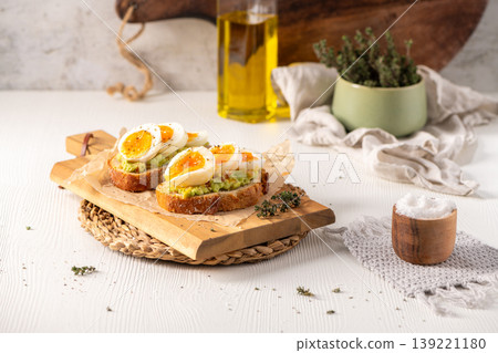 Sourdough Toast with Smashed Avocado and Soft Boiled Jammy Eggs Sourdough Toast with Smashed Avocado and Soft Boiled Jammy Eggs 139221180
