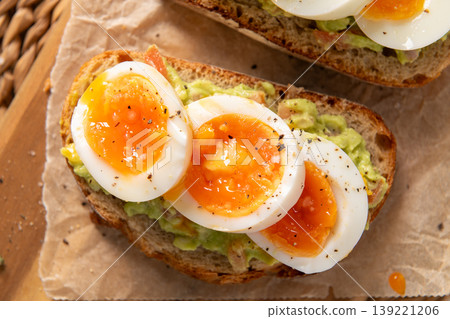 Sourdough Toast with Smashed Avocado and Soft Boiled Egg Slices Sourdough Toast with Smashed Avocado and Soft Boiled Egg Slices 139221206