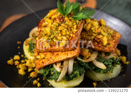 Seared Tofu with Herb Crust Served over Sauteed Greens and Sliced Potatoes Seared Tofu with Herb Crust Served over Sauteed Greens and Sliced Potatoes 139221270