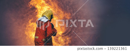 Firefighter fighting smoke flame use fire hose chemical water foam spray engine. Firefighter Rescue training in fire fighting extinguisher. Fireman wear hard hat safety suit uniform for protection Firefighter fighting smoke flame use fire hose chemical water foam spray engine. Firefighter Rescue training in fire fighting extinguisher. Fireman wear hard hat safety suit uniform for protection 139221361