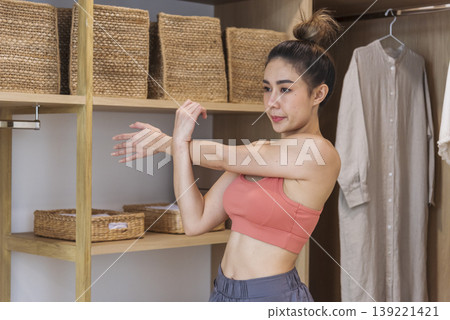 Sport Women home fitness workout exercise in living room healthy lifestyle. Asian Young woman wear wellness sportswear arms stretching firm body workout slim slender. Healthy wellness woman concept 139221421