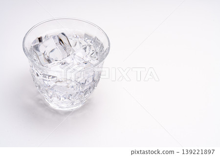 Product photography of a glass filled with ice and water against a white background. Product photography of a glass filled with ice and water against a white background. 139221897