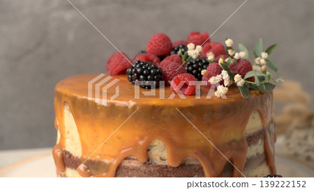 Layered Chocolate Cake with Caramel Drip Topped with Fresh Raspberries and Blackberries Layered Chocolate Cake with Caramel Drip Topped with Fresh Raspberries and Blackberries 139222152