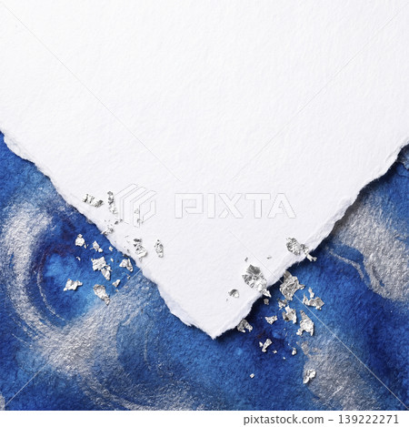 A modern background with sapphire blue watercolor and silver leaf peeking through the gaps in torn Japanese paper. A modern background with sapphire blue watercolor and silver leaf peeking through the gaps in torn Japanese paper. 139222271
