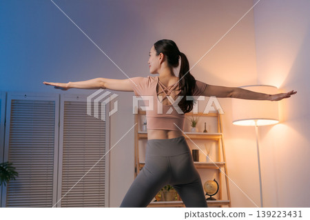 A woman who plays yoga in the room 139223431