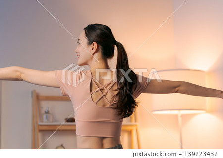 A woman who plays yoga in the room A woman who plays yoga in the room 139223432