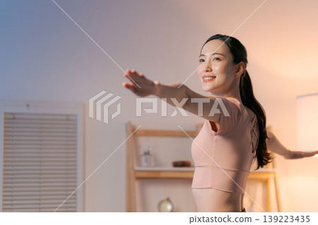 A woman who plays yoga in the room A woman who plays yoga in the room 139223435