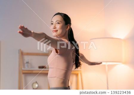 A woman who plays yoga in the room A woman who plays yoga in the room 139223436