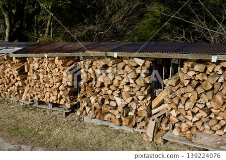 Firewood piled up outdoors Firewood piled up outdoors 139224076