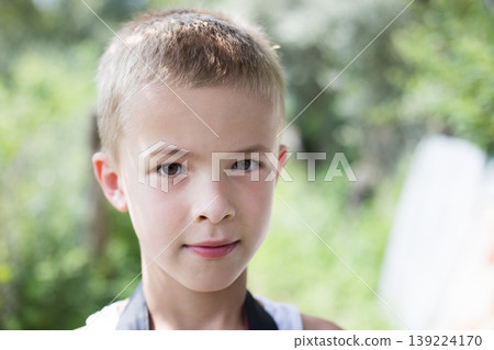 Portrait of a serious child boy outdoors. Portrait of a serious child boy outdoors. 139224170
