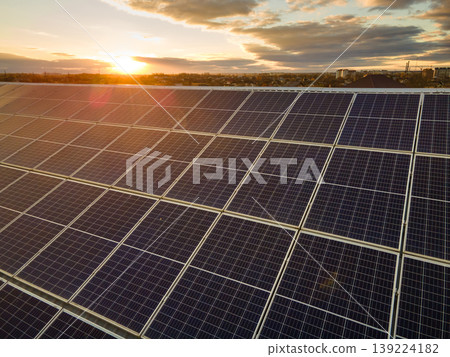 Photovoltaic panels on solar rooftops of commercial building for producing clean ecological electrical energy. Renewable electricity with zero emission concept. Photovoltaic panels on solar rooftops of commercial building for producing clean ecological electrical energy. Renewable electricity with zero emission concept. 139224182