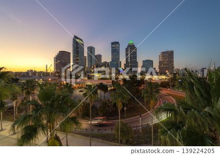 Night urban landscape of downtown district of Tampa in Florida, USA. American city skyline with brightly illuminated high commercial buildings and high speed highway road 139224205