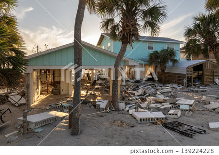 Natural disaster and its consequences. Hurricane destroyed houses roof and walls in Florida coastal area Natural disaster and its consequences. Hurricane destroyed houses roof and walls in Florida coastal area 139224228