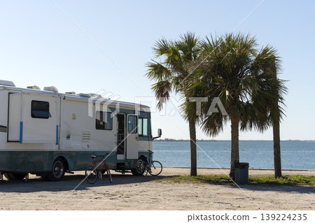 Motorhome camper recreational vehicle parked on ocean shore in Florida. USA travel infrastructure. Motorhome camper recreational vehicle parked on ocean shore in Florida. USA travel infrastructure. 139224235