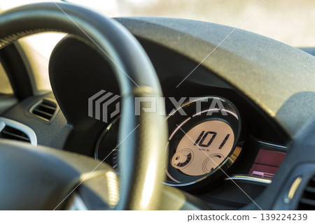 Modern car interior with driver hand on steering wheel. Safe driving concept. Modern car interior with driver hand on steering wheel. Safe driving concept. 139224239