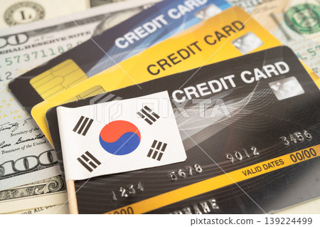 South Korea flag on coin and banknote money, finance trading investment business currency. South Korea flag on coin and banknote money, finance trading investment business currency. 139224499