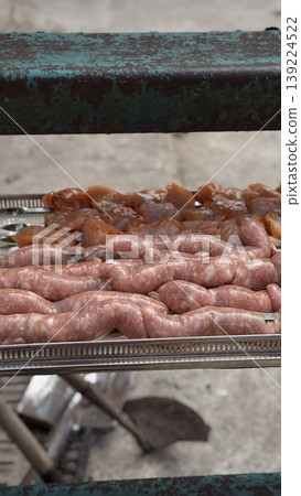 Assorted raw meats ready for grilling outdoors. Assorted raw meats ready for grilling outdoors. 139224522