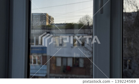 A serene view from a window showcasing urban architecture. A serene view from a window showcasing urban architecture. 139224569