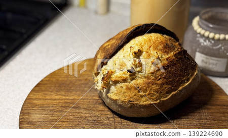 Rustic loaf of bread presented on a wooden surface. Rustic loaf of bread presented on a wooden surface. 139224690