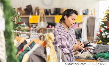 In chain shop, Indonesian man choose socks, X mas shopping In chain shop, Indonesian man choose socks, X mas shopping 139224725