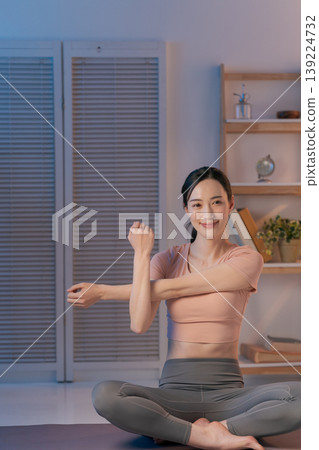 A woman who plays yoga in the room A woman who plays yoga in the room 139224732