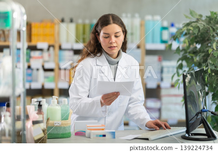 Female pharmacist checking prescription on computer Female pharmacist checking prescription on computer 139224734