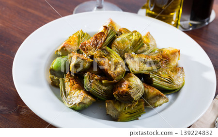 Delicious fried artichoke halves on a white plate 139224832