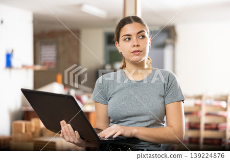 Girl using laptop to find interior design during house renovation Girl using laptop to find interior design during house renovation 139224876
