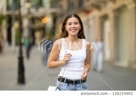 Young girl enjoying walk along summer city stree Young girl enjoying walk along summer city stree 139224902