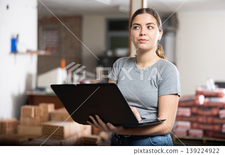 Young woman using laptop in house during renovating Young woman using laptop in house during renovating 139224922