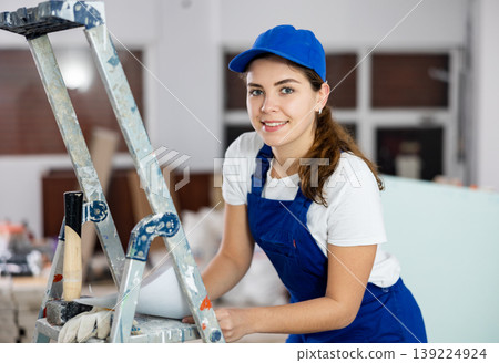 Young woman builder with documents in construction site 139224924