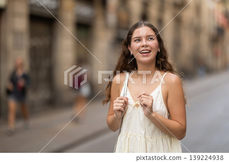 Young woman in white dress walking along the streets of the historical center of city Young woman in white dress walking along the streets of the historical center of city 139224938