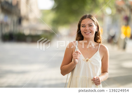 Young woman posing on city street Young woman posing on city street 139224954