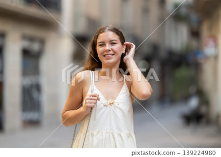 Young woman posing on city street Young woman posing on city street 139224980