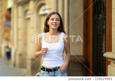 Young girl enjoying walk along summer city stree Young girl enjoying walk along summer city stree 139224991