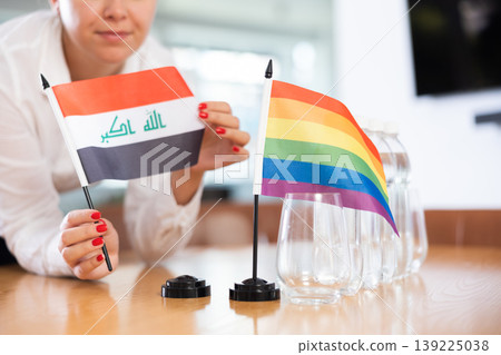 Rainbow flag and national flag of Iraq on negotiating table Rainbow flag and national flag of Iraq on negotiating table 139225038