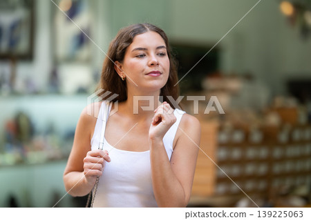 Girl looks at contents of shoes shop window assortment, Girl looks at contents of shoes shop window assortment, 139225063