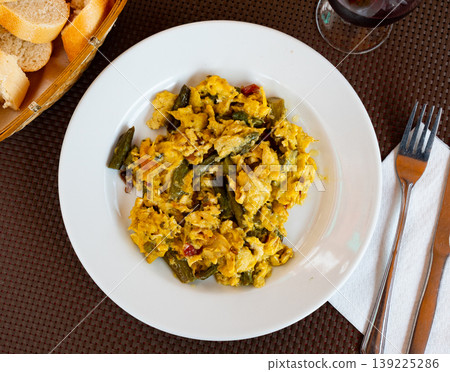 Delicate omelet with chicken and spicy ham Delicate omelet with chicken and spicy ham 139225286