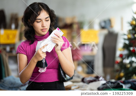 Female shopper chooses socks in clothing store Female shopper chooses socks in clothing store 139225309