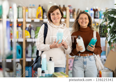 Two women choosing shampoo or shower gel in supermarket Two women choosing shampoo or shower gel in supermarket 139225341