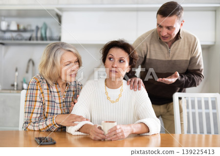 Family quarrel, old woman calming woman 139225413