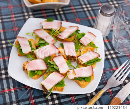Toast with bacon and arugula for breakfast Toast with bacon and arugula for breakfast 139225484
