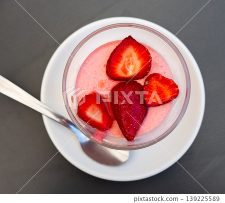 Delicious strawberry mousse in glass decorated with fresh strawberries Delicious strawberry mousse in glass decorated with fresh strawberries 139225589