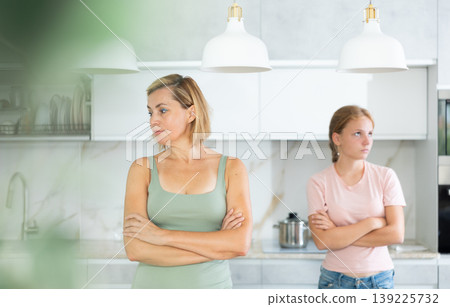 Quarreled mum and daughter do not talk ignore to each other and look in different directions. 139225732