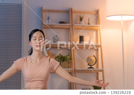 A woman who plays yoga in the room A woman who plays yoga in the room 139226228